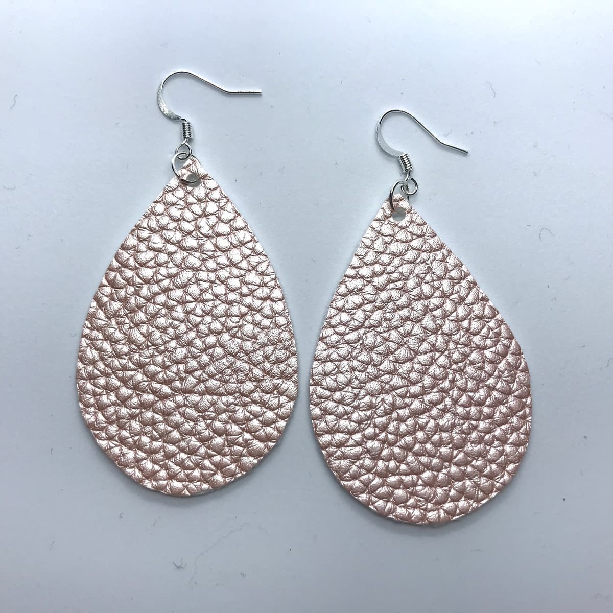 The selected image of Light Pink Pebble Textured Shimmery Leather Earrings
