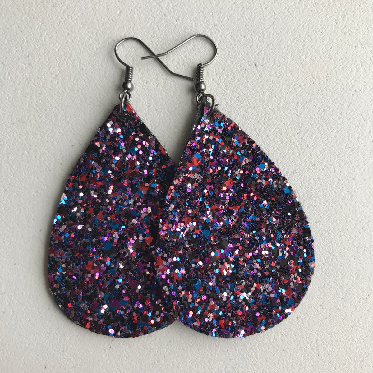 The selected image of Red, Blue, Black, and Purple Sparkly Dangle Earrings