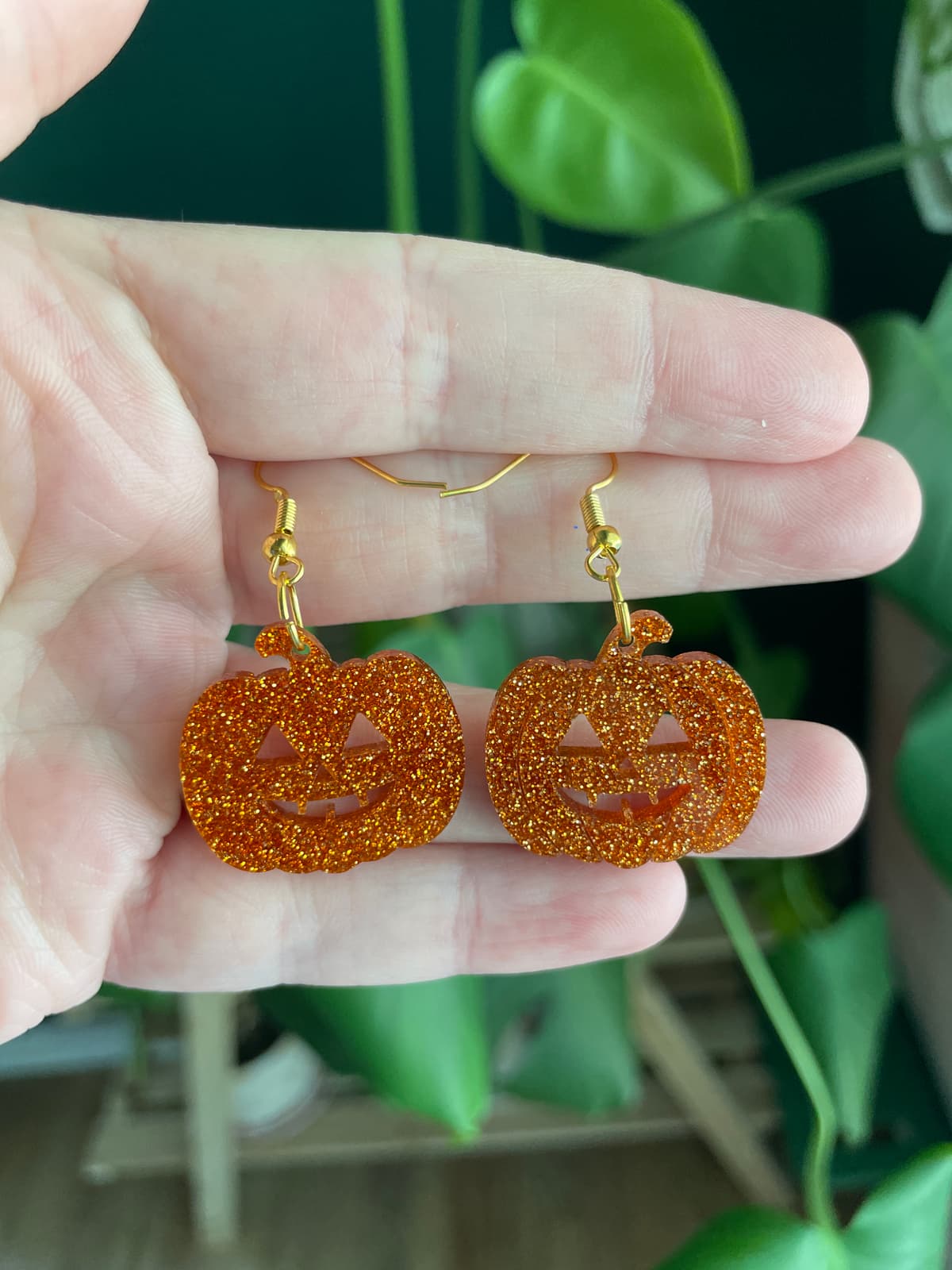 The selected image of Cute Glittery Acrylic Pumpkin Jack-o-Lantern Dangle Earrings